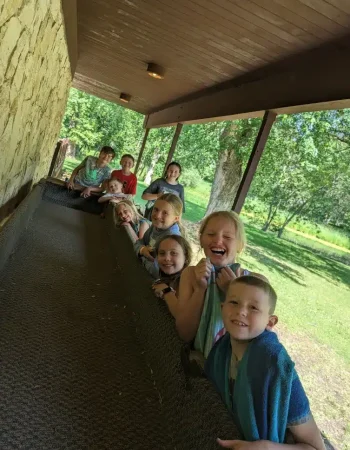 Kids smiling while leaning over a padded trough